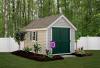 Deluxe Classic 8′ x 12′ • Classic Linen vinyl siding, green doors and shutters, white trim, slate architectural shingles